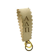 Alpha Chi Omega faux suede wristlet keychain in Pink